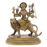 Indian patinated bronze figure of Durga on lion back, 36cm high