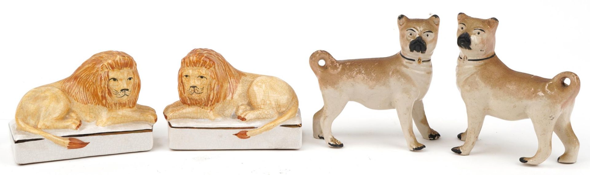 Pair of Staffordshire style dogs and a similar pair of recumbent lions, each 14.5cm wide