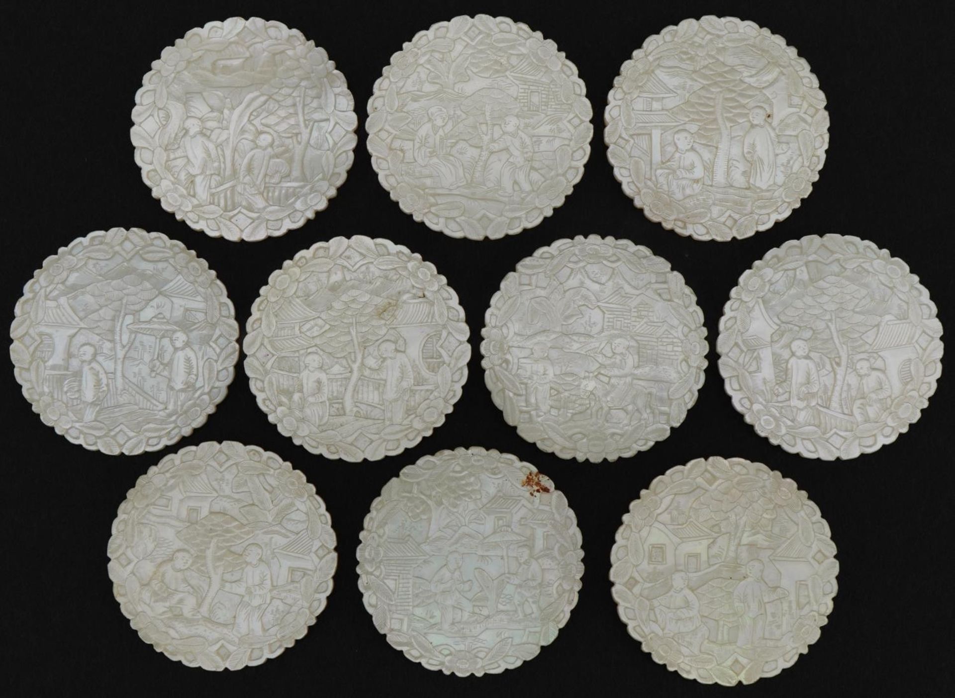 Ten good Chinese Canton mother of pearl gaming counters finely carved with figures amongst