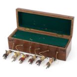 Oak cased Ascot new horseracing game with hand painted lead jockeys on horseback, 25cm wide