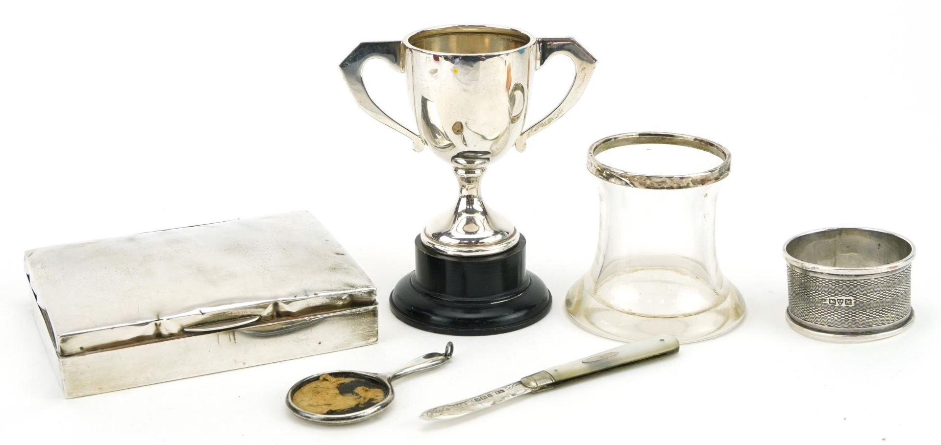 Silver objects including a cigarette box, twin handled trophy and mother of pearl folding fruit