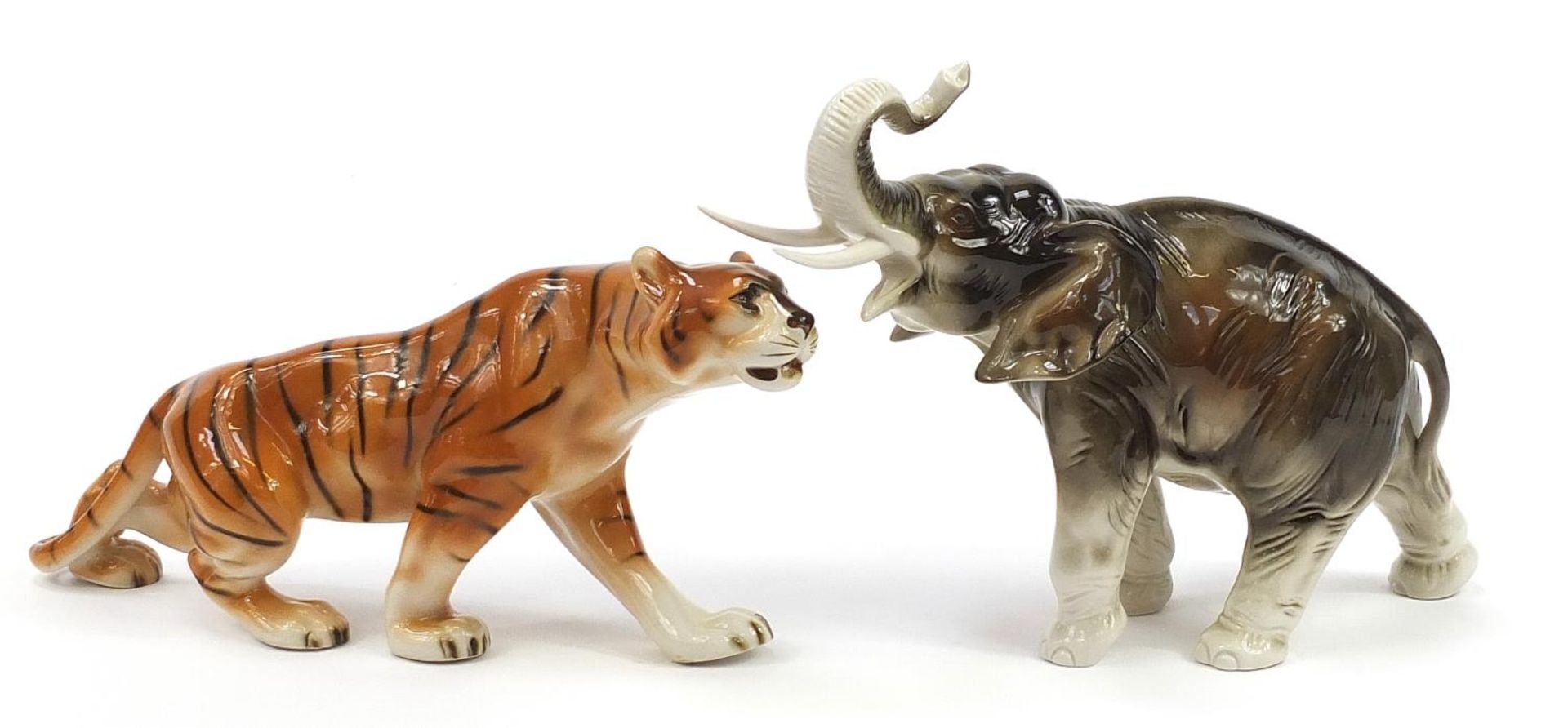 Royal Dux, Czechoslovakian porcelain elephant and tiger, the largest 36cm in length