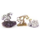 Two amethyst and gilt metal bonsai trees and a amethyst geode, the largest 14cm wide