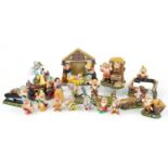 Collection of Walt Disney porcelain Snow White and the Seven Dwarfs figures including snow globe