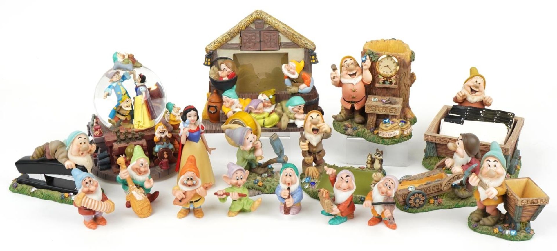 Collection of Walt Disney porcelain Snow White and the Seven Dwarfs figures including snow globe
