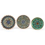 Three Turkish Kutahya pottery plates hand painted with flowers, the largest each 26cm in diameter