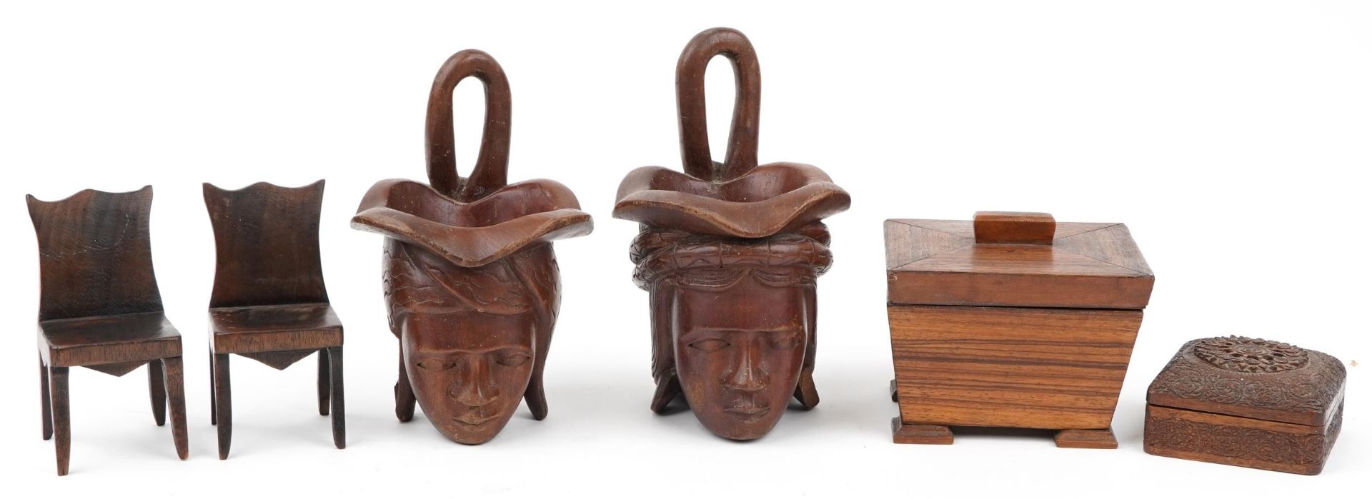 Woodenware including a rosewood casket and a pair of Indian figural cups, the largest 24cm high