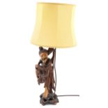 Chinese root wood table lamp with shade carved in the form of a fisherman, overall 68cm high