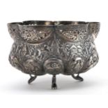 Anglo Indian unmarked silver three footed bowl embossed with wild animals and huts, 10cm in