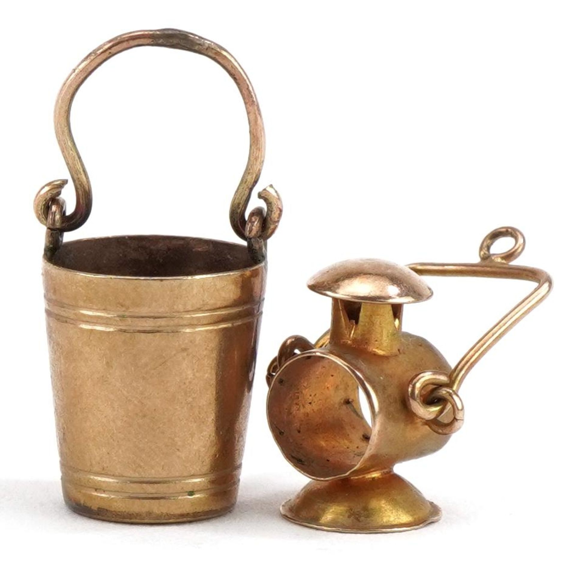 Two 9ct gold charms comprising lantern and bucket, the largest 2.3cm high, total 2.4g