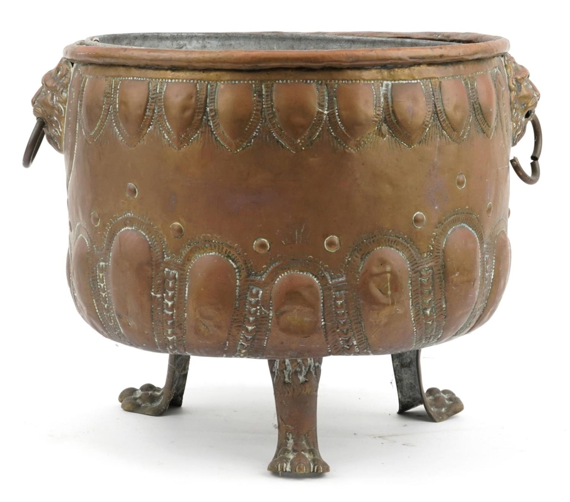 Large Victorian copper coal bucket with lion mask ring handles and raised on three lion paw feet,