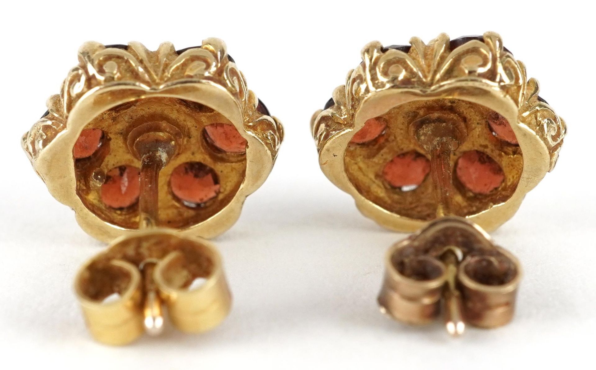 Pair of 9ct gold Bohemian garnet flower head stud earrings, one butterfly marked 750, 1.1cm in - Image 2 of 3