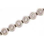 Unmarked white gold diamond line bracelet, tests as 18ct gold, 18cm in length, 13.7g : For further