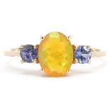 10k gold iridescent stone and tanzanite ring, the largest stone approximately 9.2mm x 7.2mm, size T,