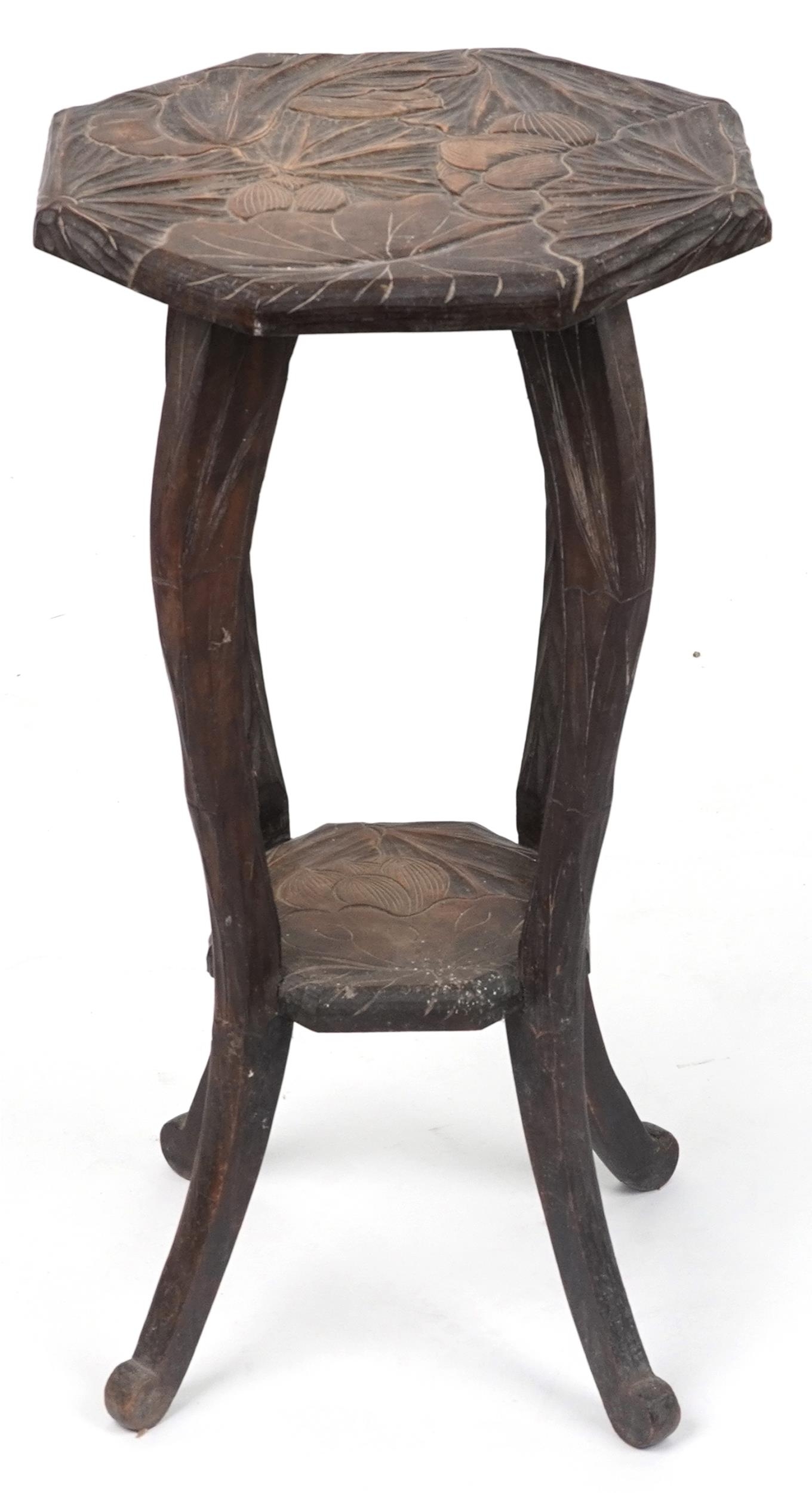 Manner of Liberty & Co, Japanese hardwood side table carved with flowers, 76cm high x 43cm in