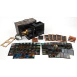 Victorian magic lantern slide projector with a selection of various glass slides including The