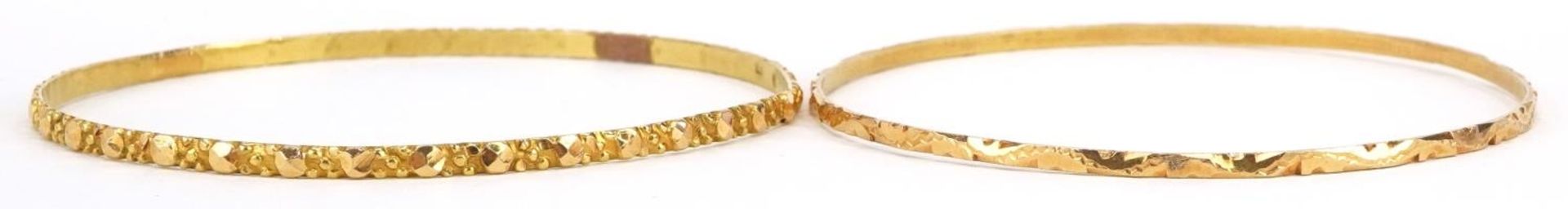 Two gold bangles, each tests as 15ct gold, 6.5cm in diameter, total 14.0g : For further