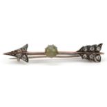 Victorian unmarked gold cabochon Chrysoberyl and clear stone arrow brooch, the cat's eye