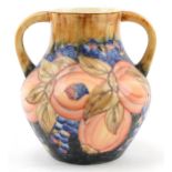 Large Moorcroft style pottery vase with twin handles hand painted and decorated with pomegranate and