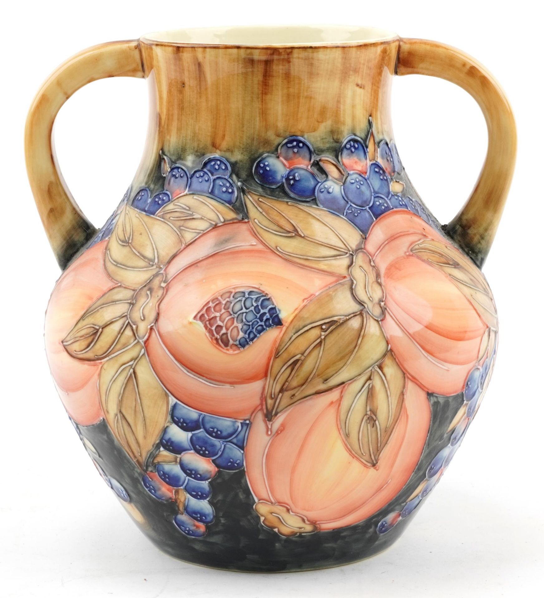 Large Moorcroft style pottery vase with twin handles hand painted and decorated with pomegranate and