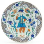 Turkish Iznik plate hand painted with a figure amongst stylised flowers, 32cm in diameter : For