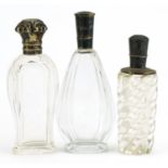 Three Dutch silver mounted glass scent bottles including two cut glass examples, the lids with