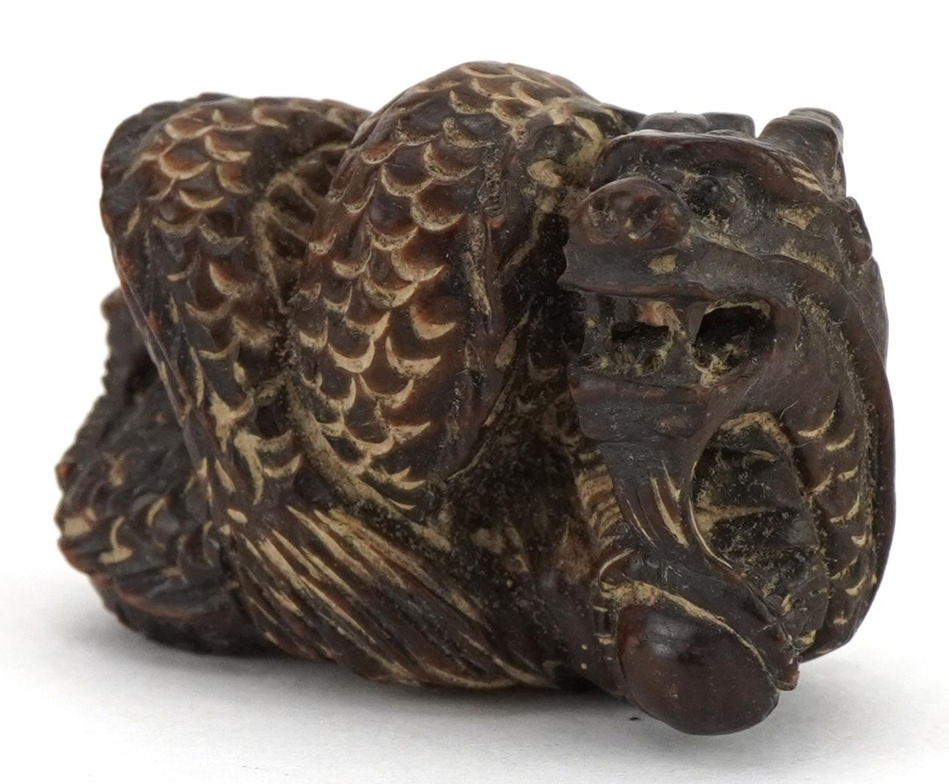 Japanese carved wood okimono in the form of a dragon, character marks to the base, 4cm in length :