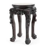 Chinese hardwood vase stand with inset marble top finely carved with mythical faces and foliage,