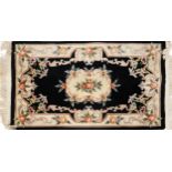 Chinese black and cream ground rug having an allover floral design, 160cm x 93cm : For further