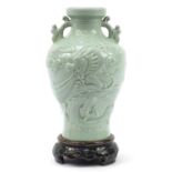 Large Chinese porcelain vase on stand with twin handles having a celadon glaze, decorated in