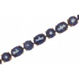 9ct gold topaz line bracelet, the largest stones approximately 8.0mm x 6.0mm, 20cm in length, 11.