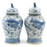 Large pair of Chinese blue and white porcelain baluster vases and covers hand painted with dragons