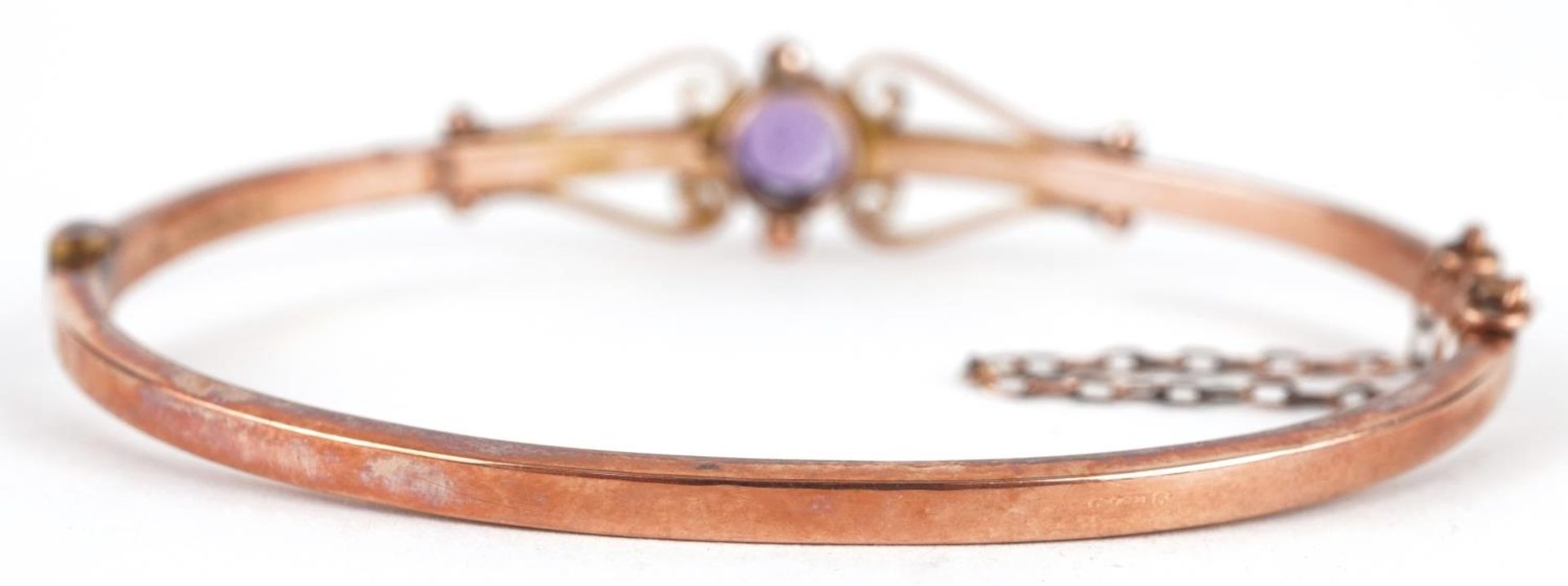 Edwardian 9ct rose gold amethyst bangle with scrolled decoration, the amethyst approximately 6.6mm - Image 2 of 4
