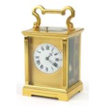 Large brass cased repeating carriage clock with circular dial having Roman numerals, 12.5cm high