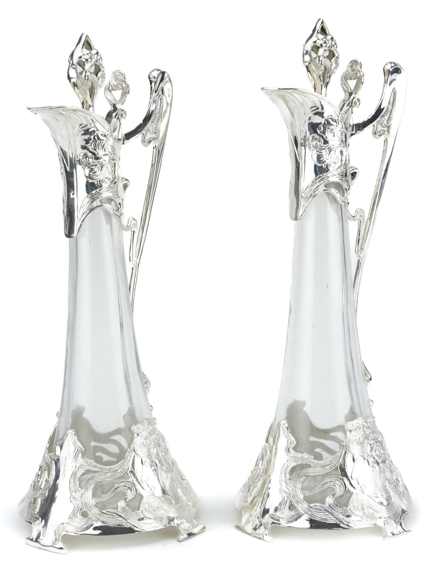 Manner of WMF, pair of Art Nouveau style glass claret jugs with silver plated mounts, each 42.5cm