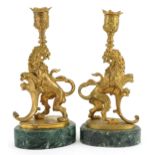 Pair of Italian style gilt metal candlesticks in the form of rampant lions raised ooval green marble