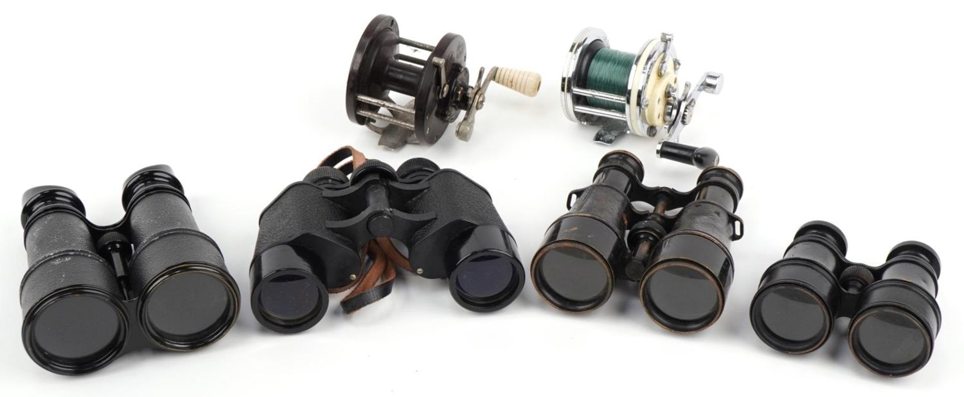 Four pairs of military interest binoculars and two vintage fishing reels, the binoculars including