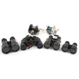 Four pairs of military interest binoculars and two vintage fishing reels, the binoculars including