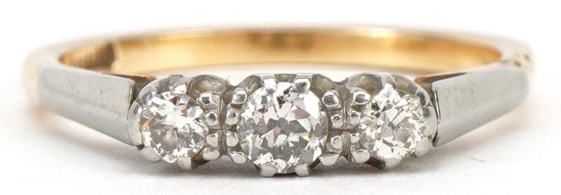 18ct gold diamond three stone ring, the largest diamond approximately 3.0mm in diameter, size M, 2.
