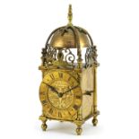 18th century style brass lantern clock with foliate engraved face and chapter ring having Roman
