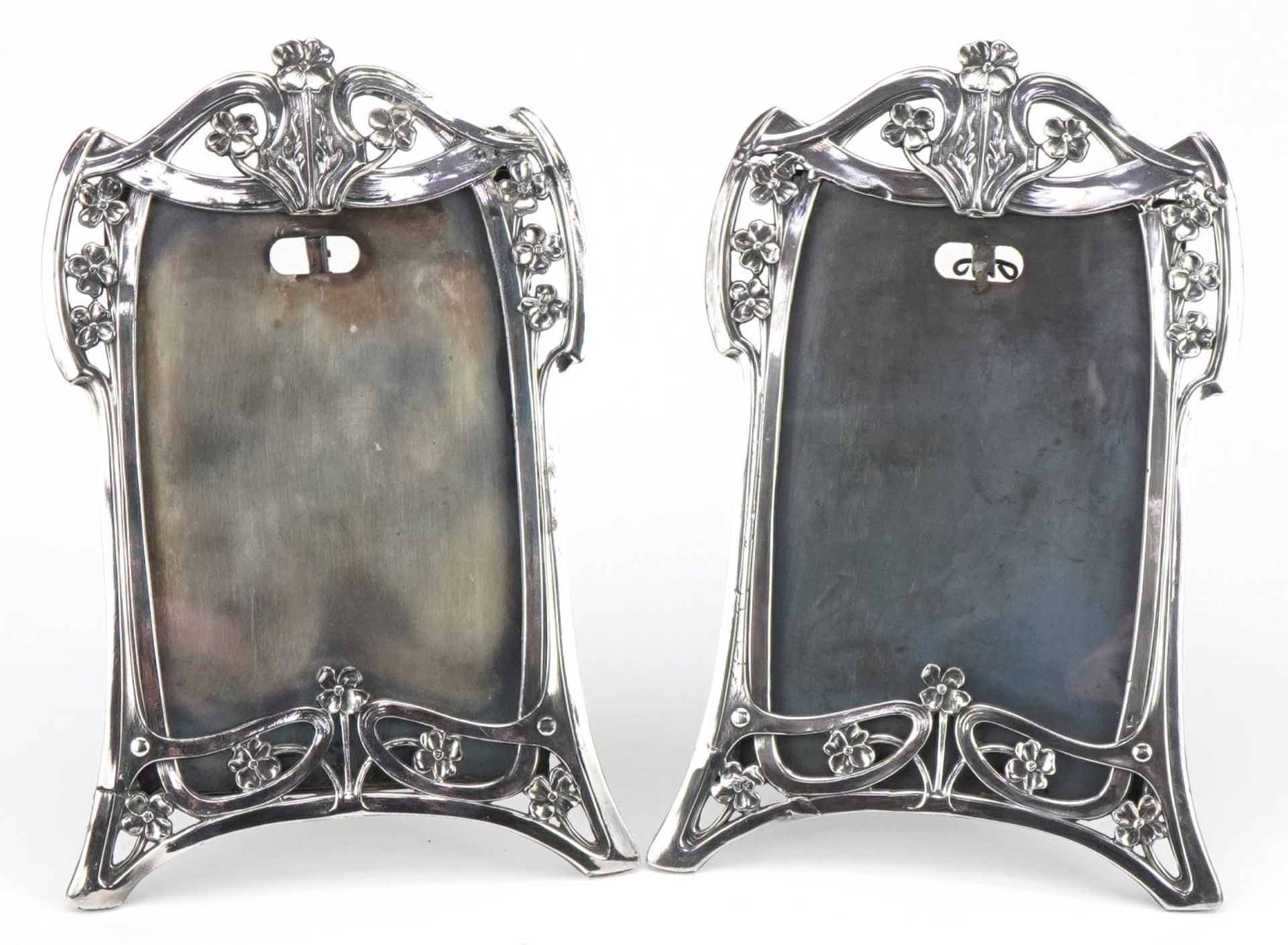 Manner of WMF, pair of Art Nouveau pewter easel photo frames cast and pierced with stylised flowers,