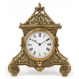 Victorian classical brass strut clock with circular enamelled dial having Roman numerals and urn