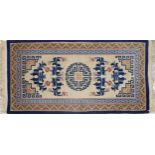 Chinese blue and cream ground rug having an allover geometric and floral design, 190cm x 94cm :