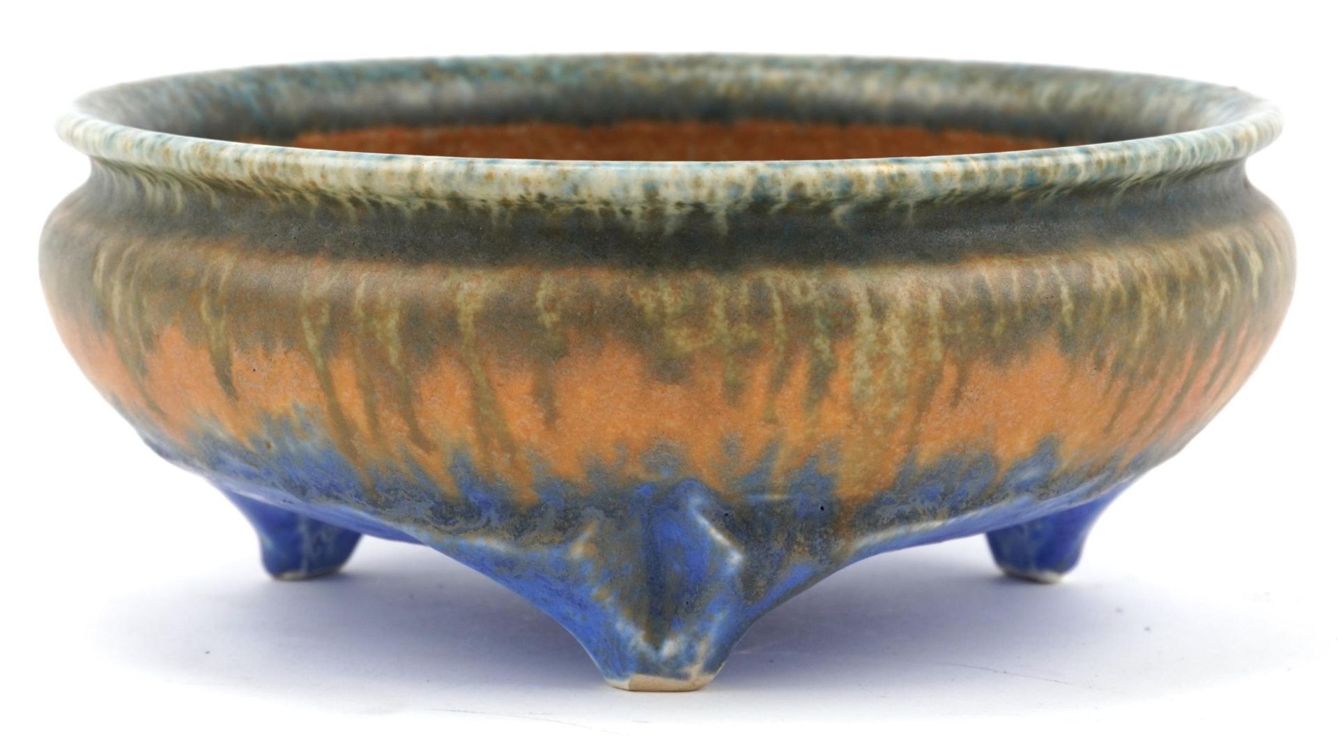 Ruskin, Arts & Crafts three footed bowl having a mottled green, orange and blue glaze, impressed