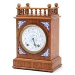 German aesthetic oak mantle clock striking on a gong with floral enamelled panels and dial having