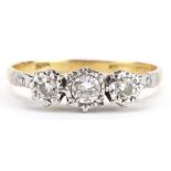 18ct gold and platinum diamond three stone ring, the largest diamond approximately 0.20 carat,