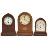 Three oak and walnut mantle clocks including an inlaid example inscribed Gilbert and a Junghans