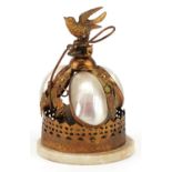 19th/20th century gilt metal and mother of pearl table bell in the form of a bird surmounted on a