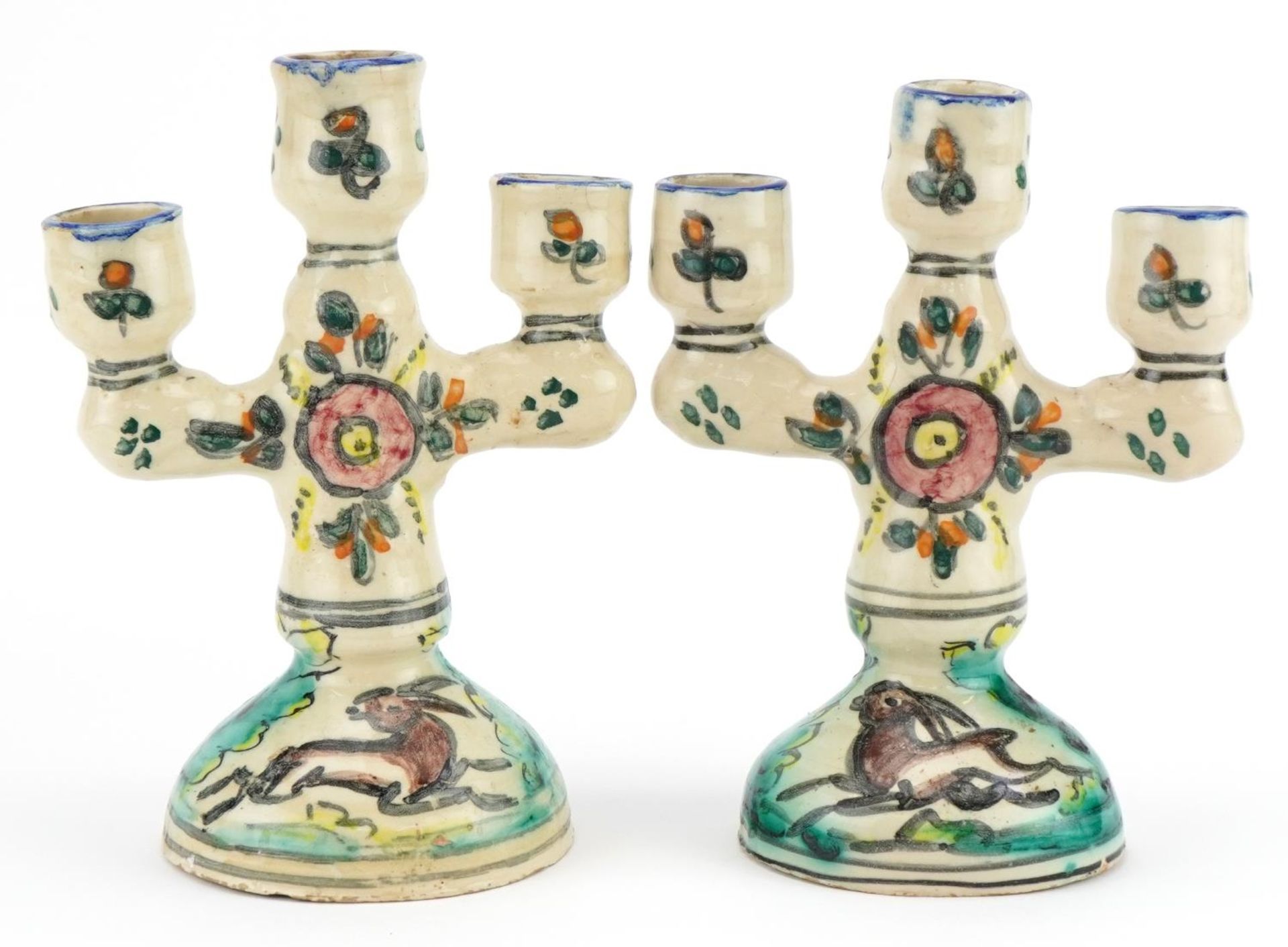 Pair of Turkish pottery three branch candelabras hand painted with birds and flowers, 19cm high :