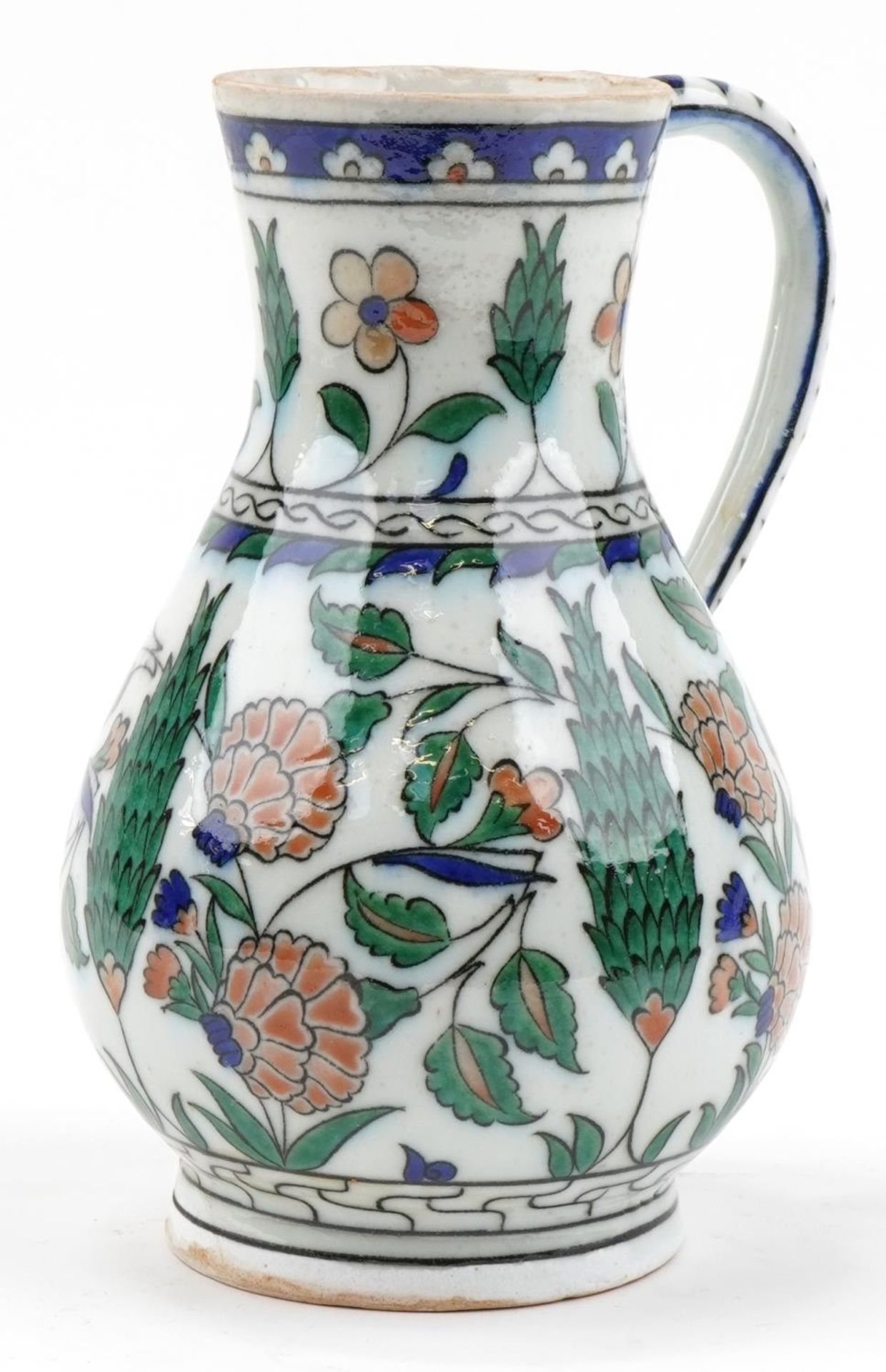 Turkish Iznik pottery handled jug hand painted with stylised flowers, 25cm high : For further